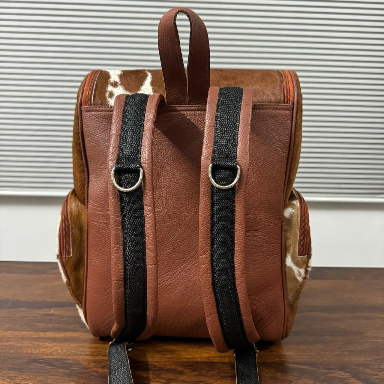 Cowhide backpack back view showing stitching and hardware