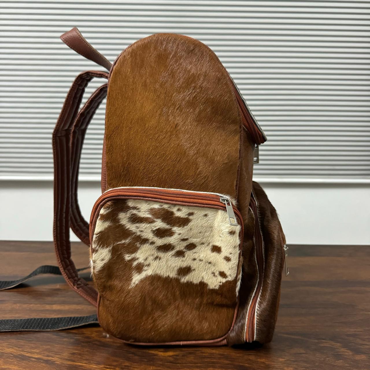 Cowhide backpack carried on shoulder, size reference