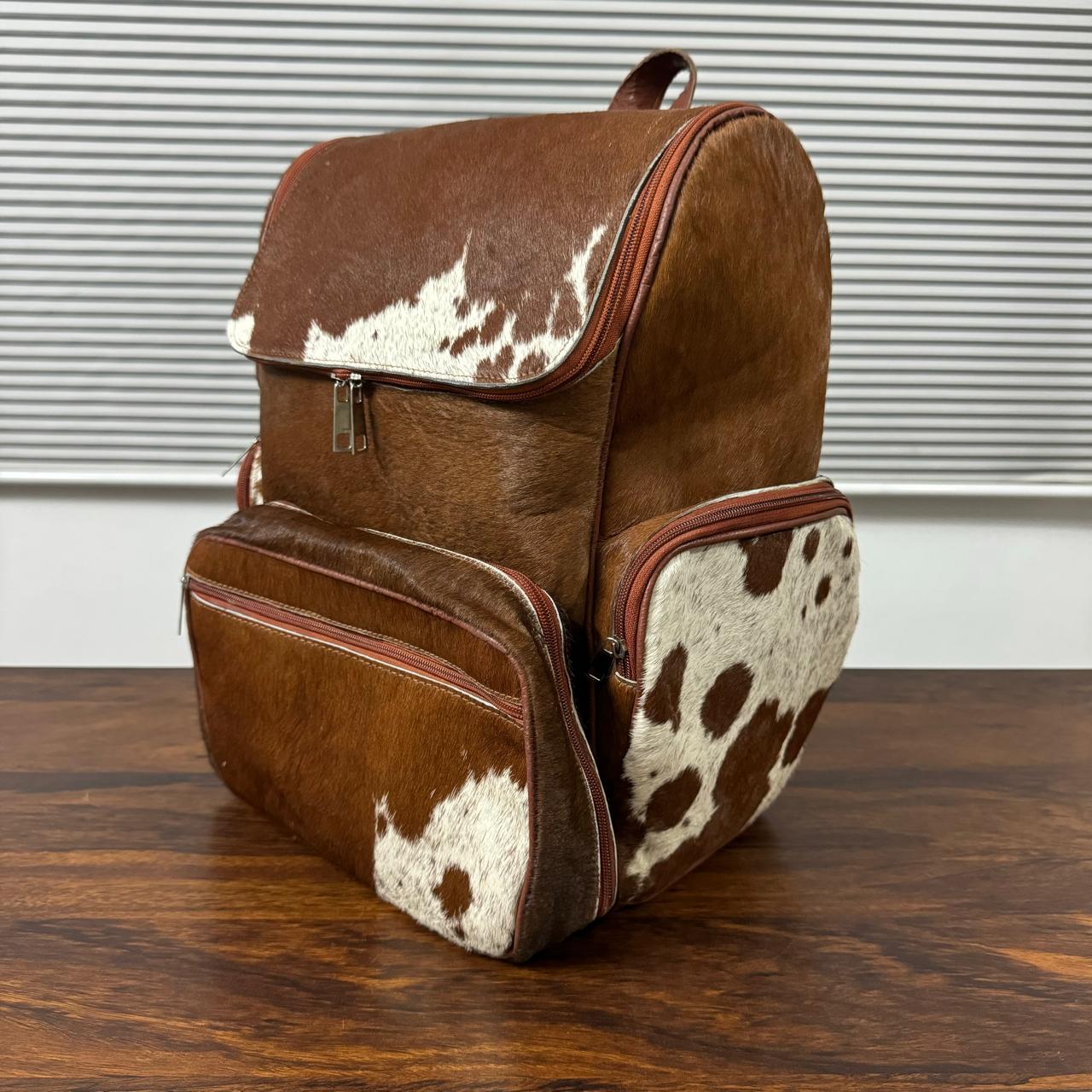 Cowhide backpack interior compartment with laptop and organizer pockets