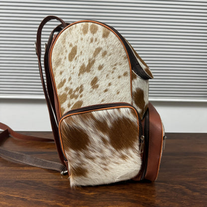 Cowhide backpack left side view with adjustable full-grain leather straps