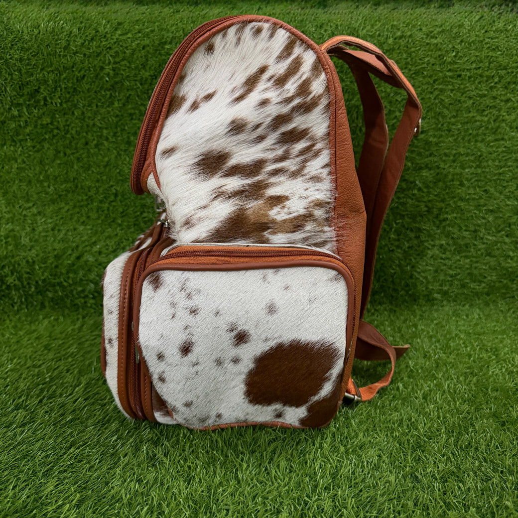 Cowhide backpack with removable strap attached to suitcase handle
