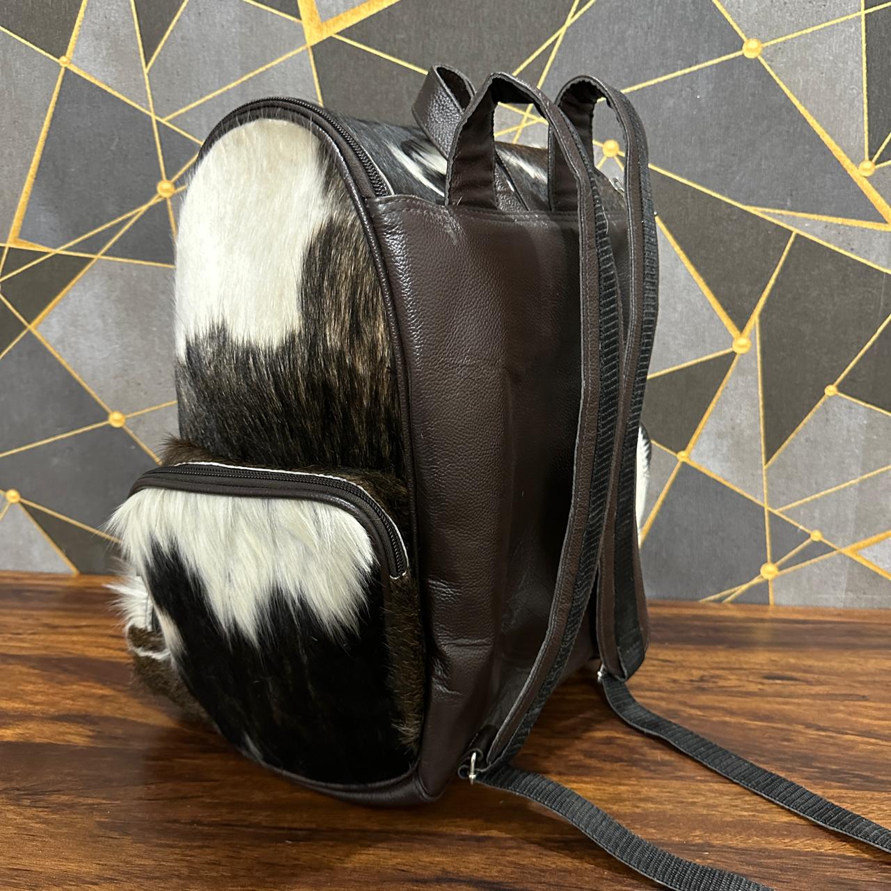 Cowhide diaper backpack with removable suitcase strap attached