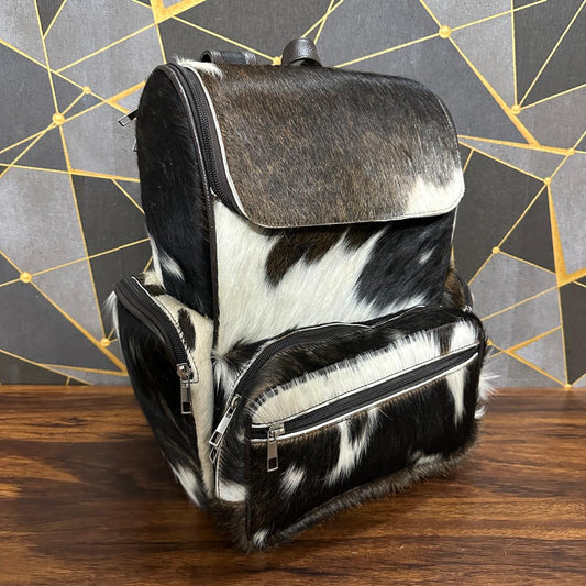 Cowhide diaper bag side view showing shoulder straps
