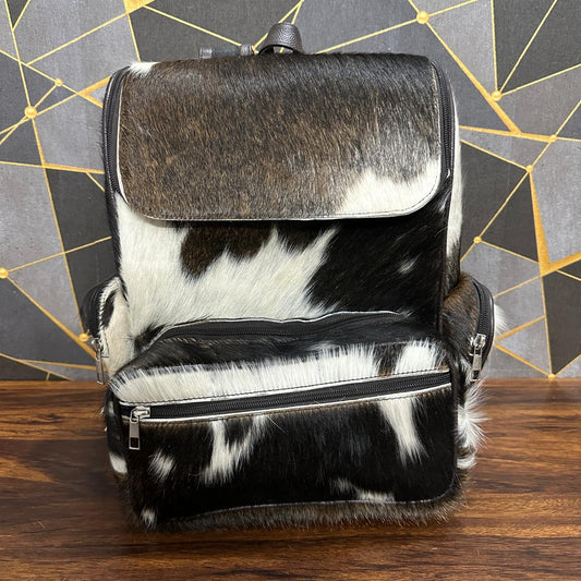 Cowhide leather diaper backpack front view, natural fur finish