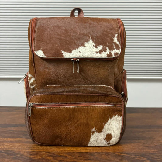 Hair-on cowhide leather backpack front view, brown and white natural pattern