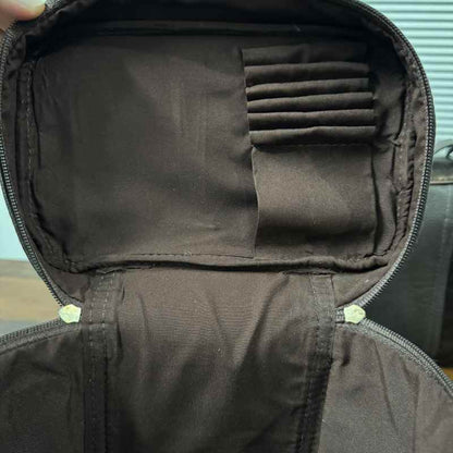inside veiw of Black and white cowhide cosmetic and toiletry travel bags with leather trim and zipper closure