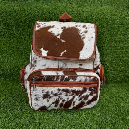 Front zip pocket and tan leather trim detail on backpack
