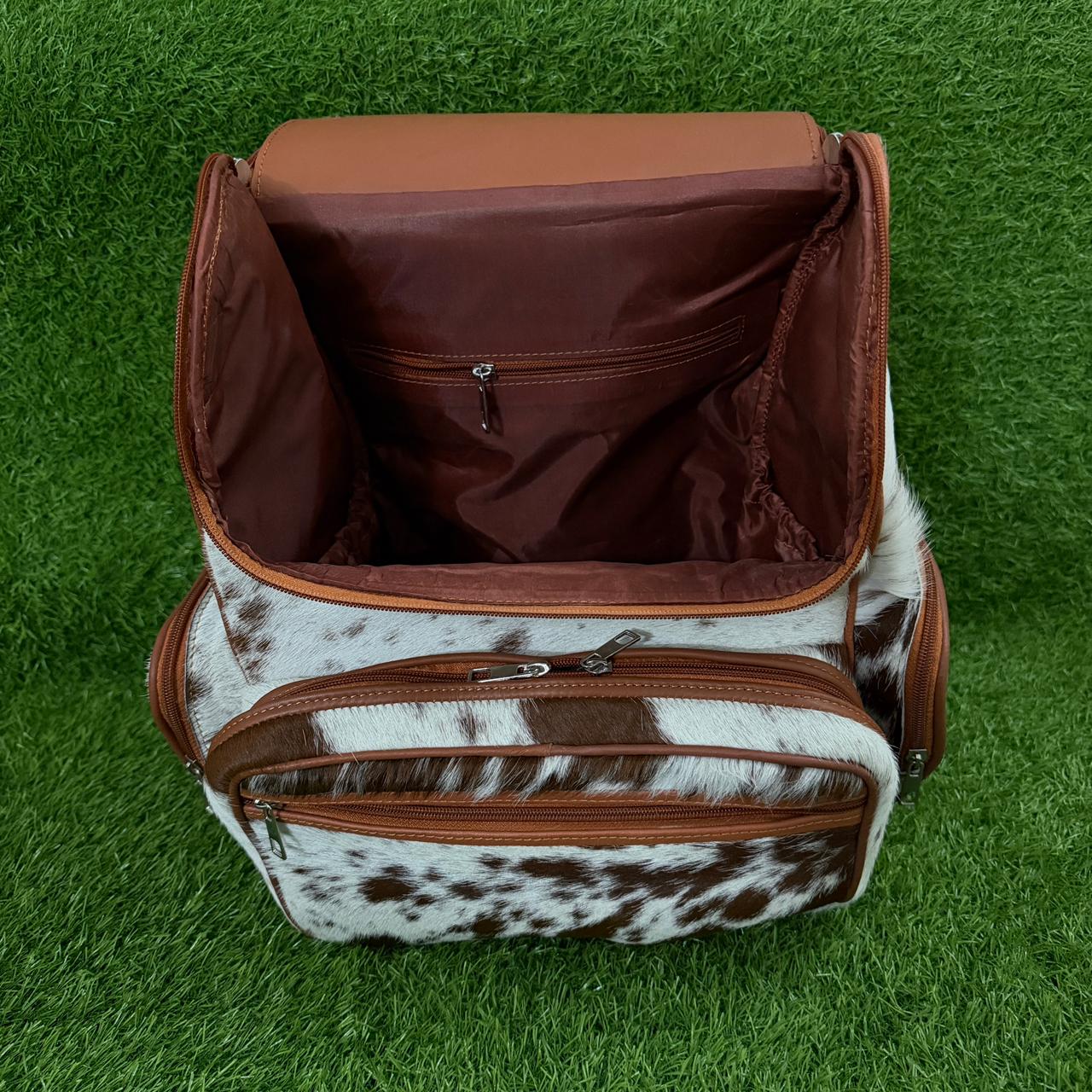 open veiw of Cowhide leather backpack brown white speckled with tan trim