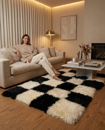 Black and white patchwork sheepskin area rug beneath a living room seating area
