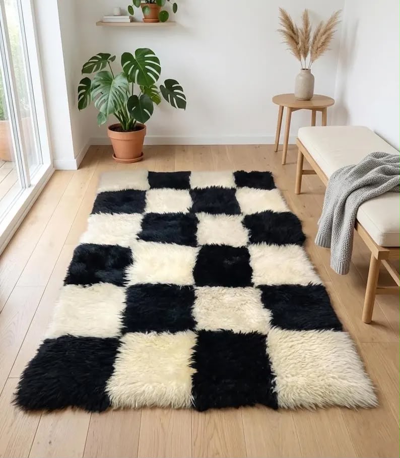 Black and white patchwork sheepskin rug styled in a modern living room