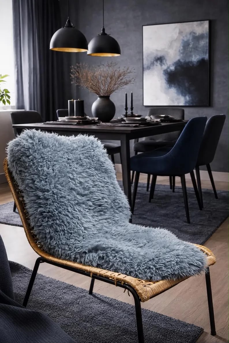 Blue natural sheepskin rug draped over a woven lounge chair in a modern dining room