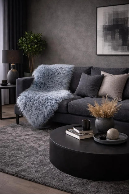 Blue sheepskin rug draped over a dark sofa in a modern living room