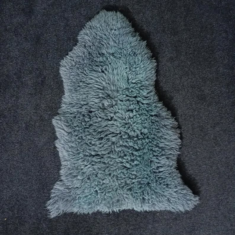 Blue single pelt sheepskin rug showing its natural shape and wool texture