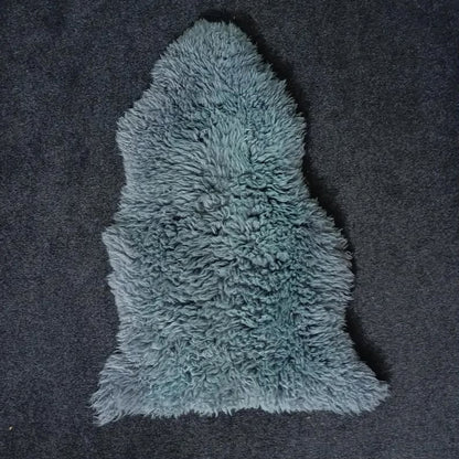 Blue single pelt sheepskin rug showing its natural shape and wool texture
