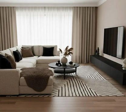 Brown natural sheepskin rug styled over a cream ottoman in a modern living room