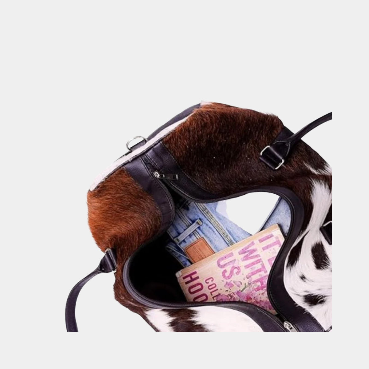 End pocket and cowhide pattern on brown and white duffel bag