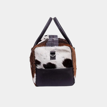 Interior of cowhide duffel bag showing zippered storage pocket