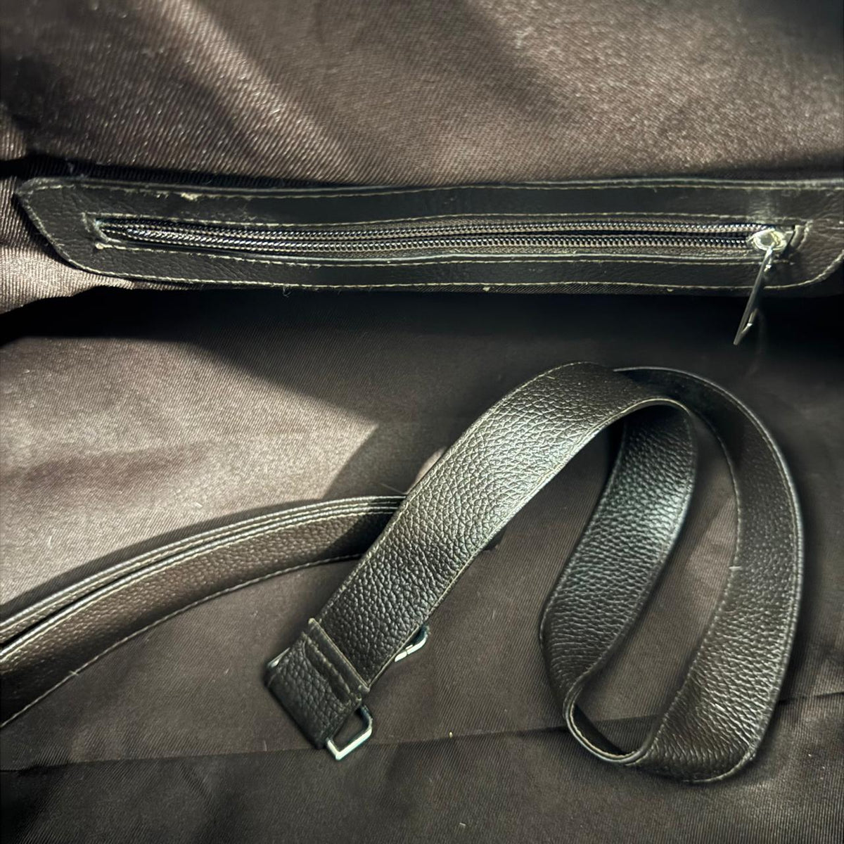 Adjustable shoulder strap for brown and white cowhide duffel bag