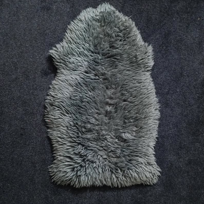 Charcoal grey single pelt sheepskin rug showing its natural shape and wool texture