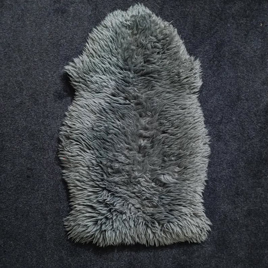 Charcoal grey single pelt sheepskin rug showing its natural shape and wool texture