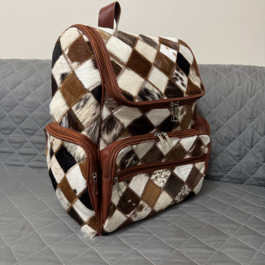 Checkered patterned backpack with brown accents on a gray surface