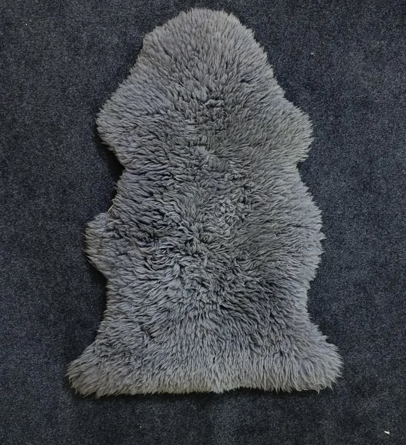 Grey single pelt sheepskin rug showing its natural shape and wool texture