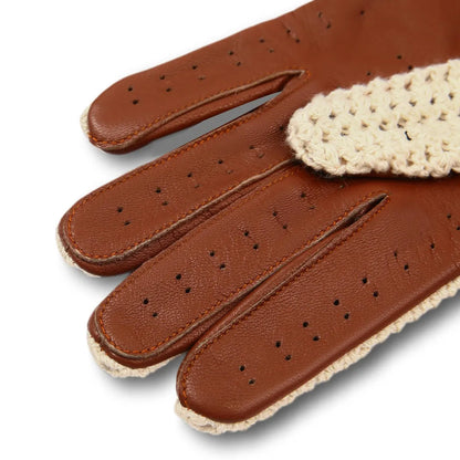 A close-up of a brown leather glove with perforated finger sections and a cream-colored crocheted cuff, shown on a white background.