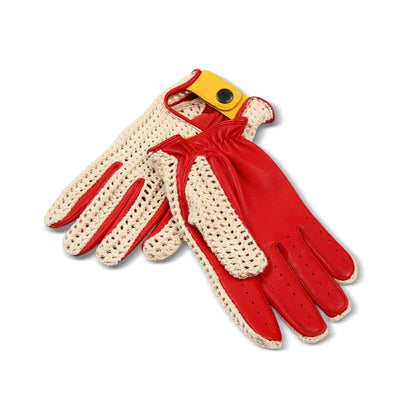 A pair of knit and leather racing gloves in red and cream, featuring a yellow wrist strap with a black snap button.
