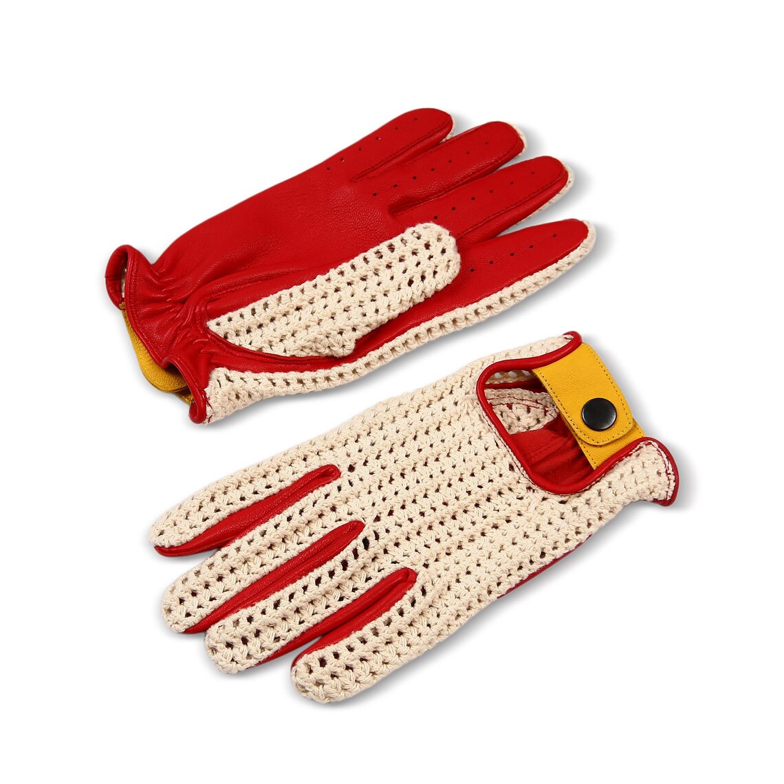 A pair of knit driving gloves with red palms and fingers, cream mesh backings, and a yellow wrist strap with a snap button, shown on a white background.