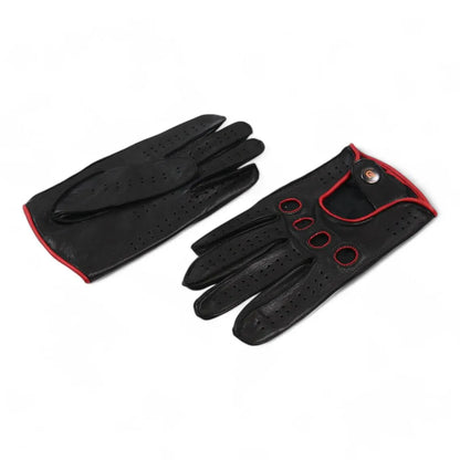 A pair of black leather golf gloves with red trim and ventilation perforations, displayed on a clean white background.