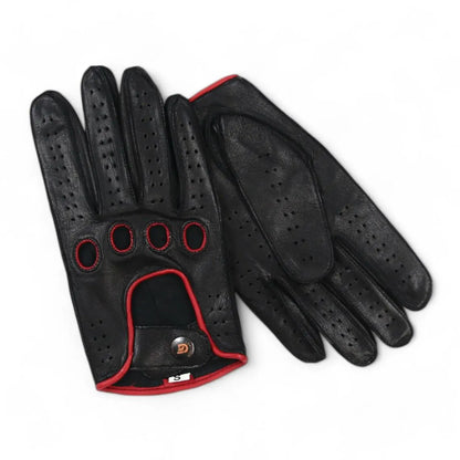 A pair of black leather golf gloves with red trim and perforations, displayed on a clean white background.