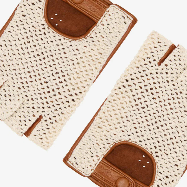 A pair of cream-colored open-knit fingerless gloves with brown leather accents, shown on a clean white background.