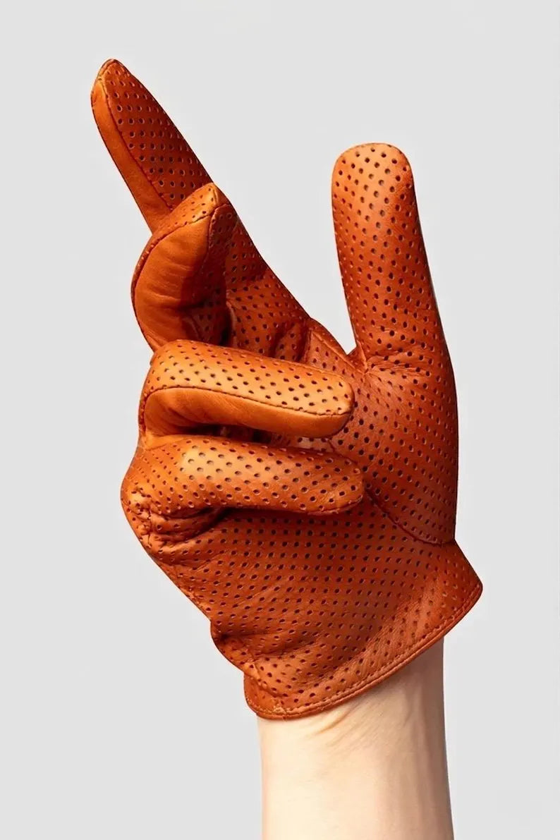 A single brown leather glove with perforated dots, held up by a hand against a light gray background.