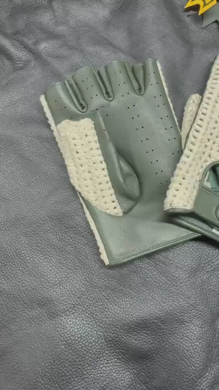 A pair of fingerless gloves with olive green leather panels and a beige open-knit mesh back