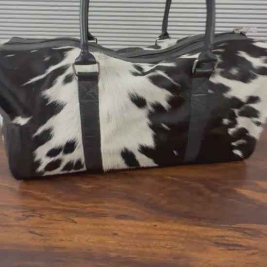 Close-up of natural spotted cowhide texture on duffel bag Video