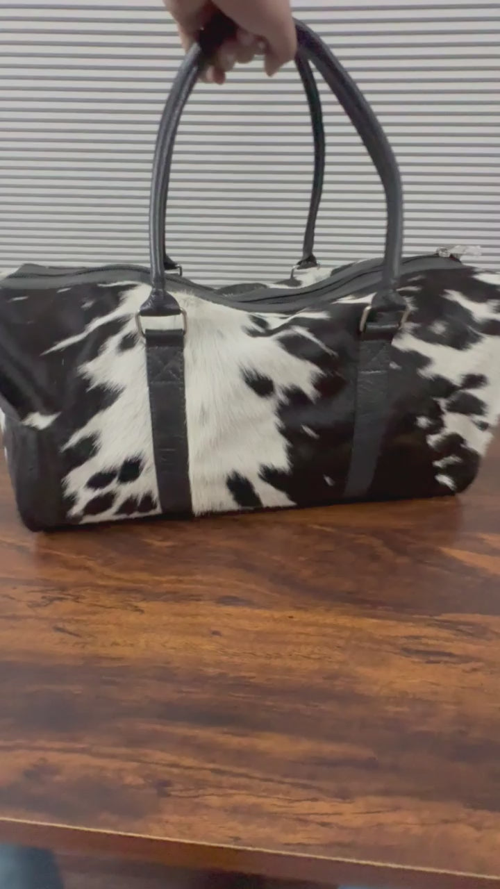 Close-up of natural spotted cowhide texture on duffel bag Video