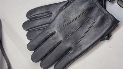 video of A pair of cream-colored open-knit fingerless gloves with brown leather accents, shown on a clean white background.