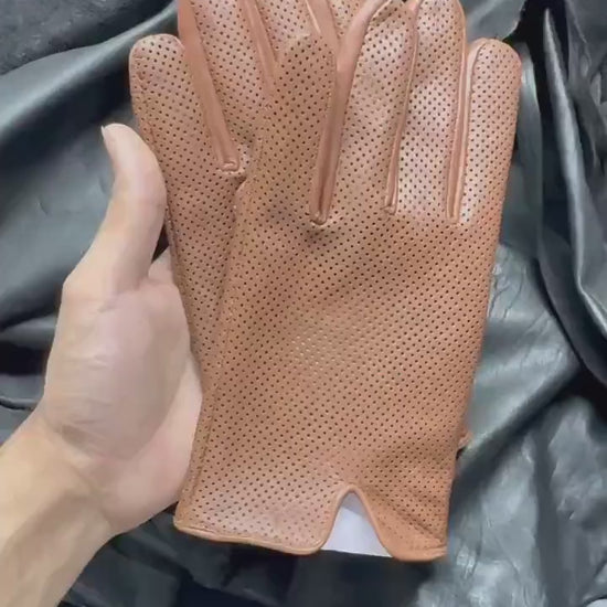 video of A pair of  brown leather glove with perforated dots,