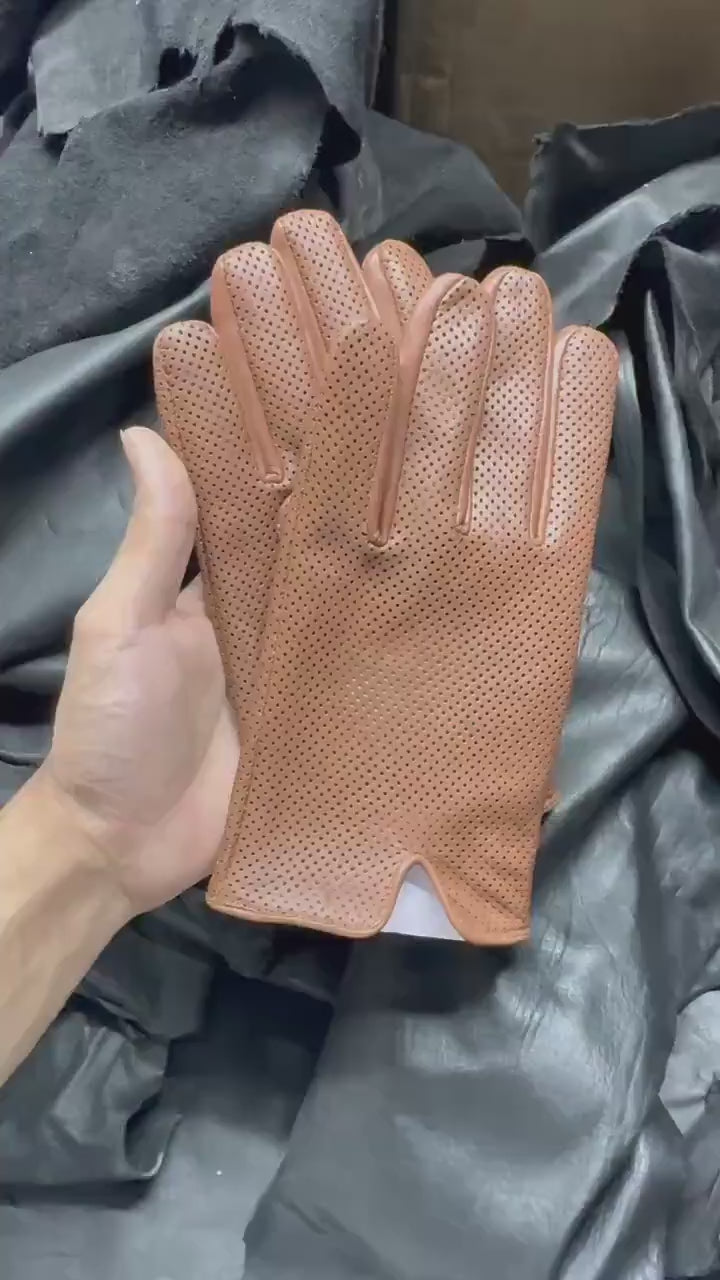 video of A pair of  brown leather glove with perforated dots,