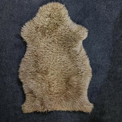 Taupe sheepskin pelt rug showing its natural shape and wool texture
